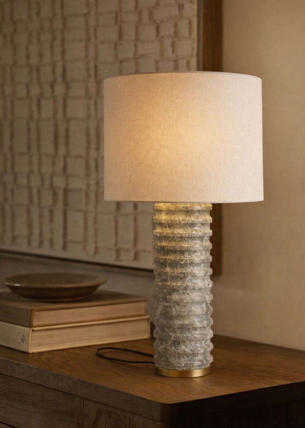Table lamp with textured base on a wooden surface, soft lighting